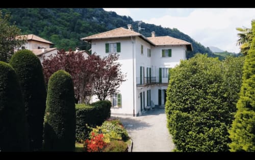 Lake Orta Retreat B&B, elegant white villa with green shutters surrounded by manicured hedges in San Maurizio D'Opaglio