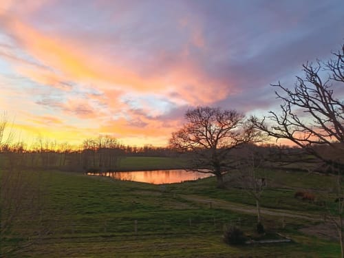 Sunset over the pond at Domaine de Beau Site in Peyrat-de-Bellac, France