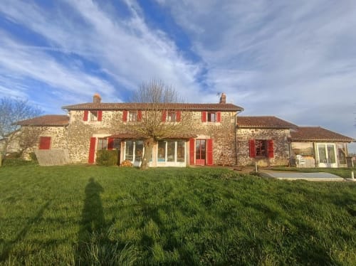 Domaine de Beau Site B&B stone villa with red shutters in Peyrat-de-Bellac, France