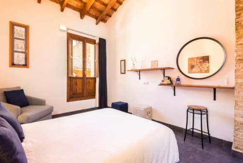 Premium double bedroom at Casa Sibarita in Rafelguaraf with city view, wooden beams, and modern furnishings