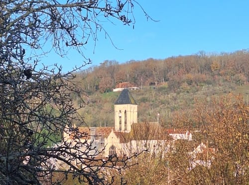La Villa Malzy cottage with church tower in picturesque Alsatian village valley surrounded by autumn forests