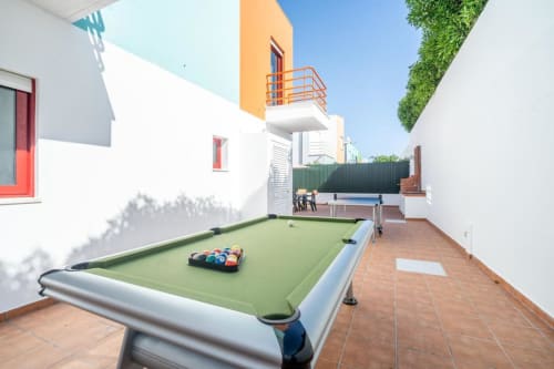 Área de lazer Villa Odyssey em Albufeira com mesa de bilhar, ping-pong e terraço no pátio