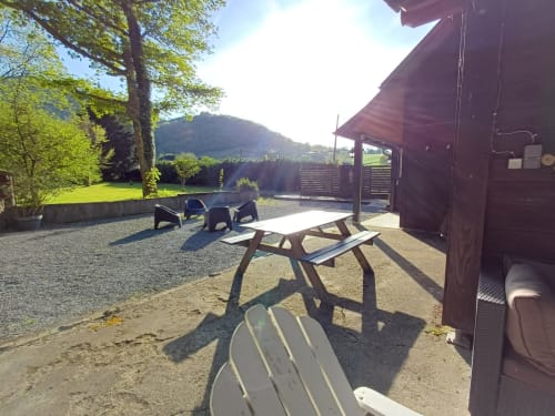 Outdoor patio with picnic tables and lounge chairs at Le gite des mousquetaires BnB in Lanne en Baretous, France
