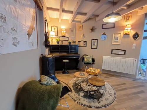 Cozy music room at Le gite des mousquetaires B&B in Lanne en Baretous with piano, comfortable seating, and warm lighting