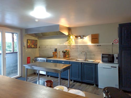 Modern kitchen at Le gite des mousquetaires in Lanne en Baretous with blue cabinets and stainless steel island