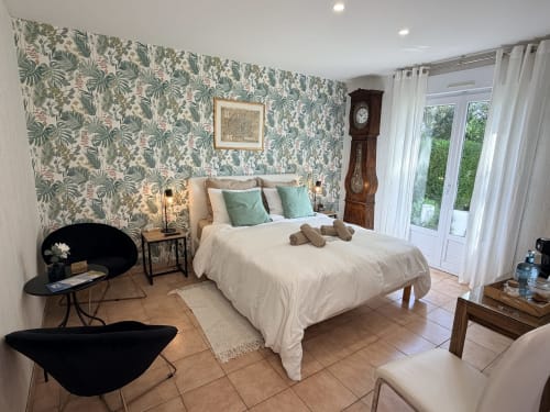 Chambre double élégante aux Vieilles Digues avec papier peint botanique, vue sur le jardin et équipements modernes à Beauvoir