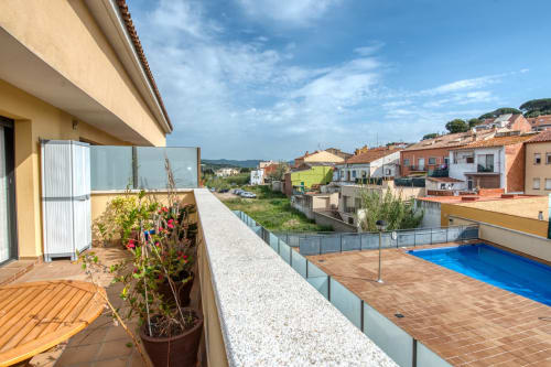 Modern terrace with pool view at Hotel Garcia, Mediterranean setting with blooming plants and coastal town architecture