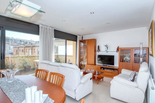Modern living room at Hotel Garcia with wooden furniture, comfortable seating, and city views in Barcelona area property