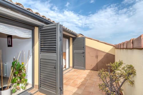Modern terrace with louvered doors at hotel in Costa-located property manager accommodation