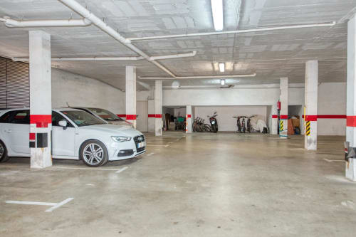 Underground parking garage at Hotel with white car and storage spaces