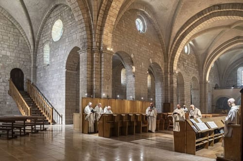 Medieval stone chapel interior with vaulted ceilings at monks in prayer, part of the historic charm of La Guard-adhémar,