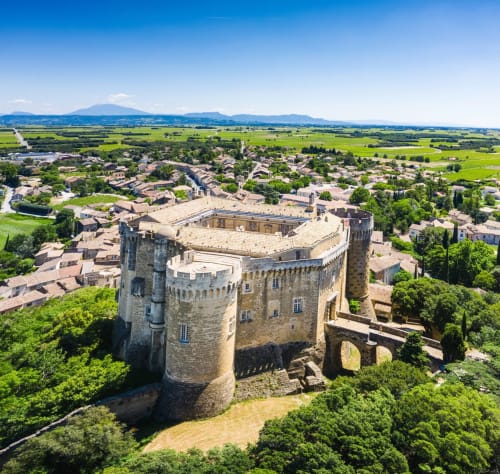 Medieval castle overlooking La-Guard-ad-hé mar village and green French countryside landscapes