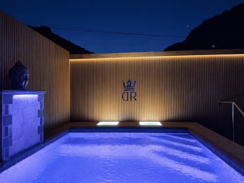 Night view of illuminated heated pool at Villa DR in La aldea. Blue-lit private villa pool with mountains visible at