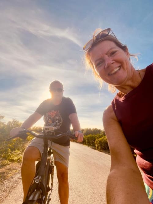 Two cyclists enjoy an outdoor adventure near Casa Sibarita in Rafelguaraf, Spain at sunset