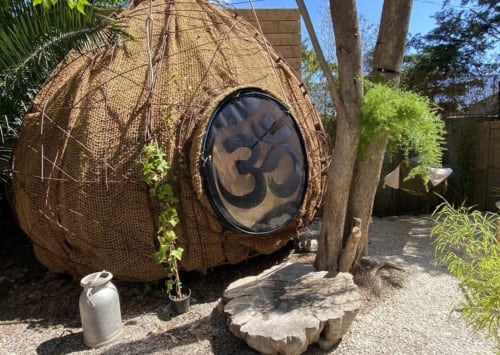 Woven pod-shaped meditation hut with Om symbol at Le Patio aux Oiseaux boutique hotel in La Ciotat, France