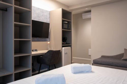 Camera Sodalite presso SMalL Guesthouse a Bussolengo con letto, scrivania, scaffali e area soggiorno