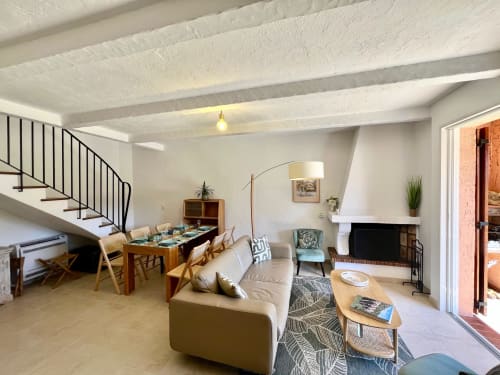 Modern villa interior at Capleouna, Cap d'Antibes with dining area, fireplace, and staircase