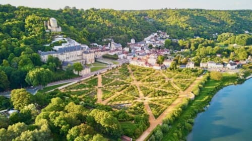 Aerial view of La Villa Malzy castle with formal gardens overlooking the Dordogne River in Vétheuil, France