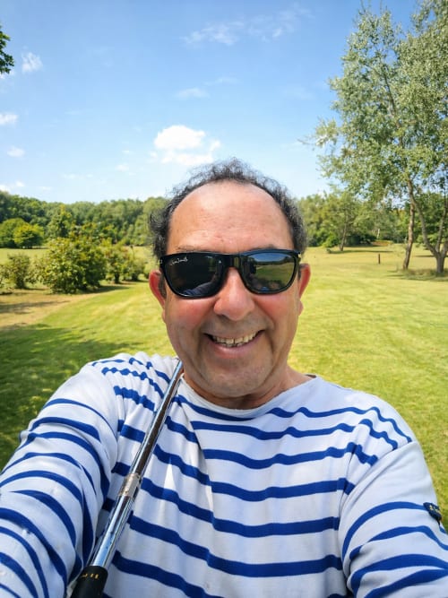 Smiling man in striped shirt and sunglasses at La Villa Malzy, Vétheuil countryside