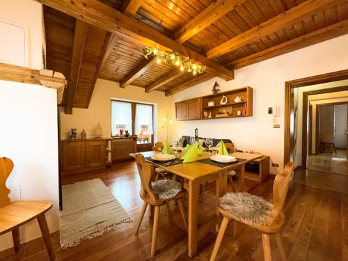 Rustic wooden dining room with mountain view in Belvedere Solferino apartment, Auronzo di Cadore
