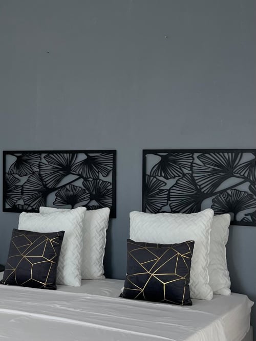 Modern bedroom at Kaz Kafe studio with black fan-pattern headboards, white pillows, and geometric accent pillows