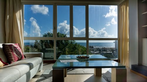 Luxury penthouse in Como with panoramic views of Tyrrhenian Sea, mountains, and coastal landscape from floor-to-ceiling