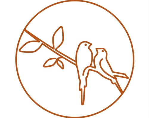 Two birds perched on a branch with leaves at Le Patio aux Oiseaux, a charming bed and breakfast in La Ciotat, France