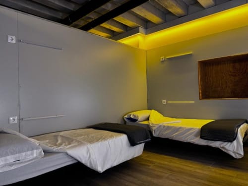 Beds in mixed dormitory at Albergue Santiago de Caminha hostel in Caminha, Portugal -Room in a mixed dormitory with air conditioning and Shared bathroom with shower. Tiled floor. Max occupancy: 1 person. Caminho Português da Costa - Camino de Santiago. Coastal way Senda Litoral
