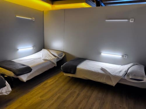 Beds in mixed dormitory at Albergue Santiago de Caminha hostel in Caminha, Portugal -Room in a mixed dormitory with air conditioning and Shared bathroom with shower. Tiled floor. Max occupancy: 1 person. Caminho Português da Costa - Camino de Santiago. Coastal way Senda Litoral