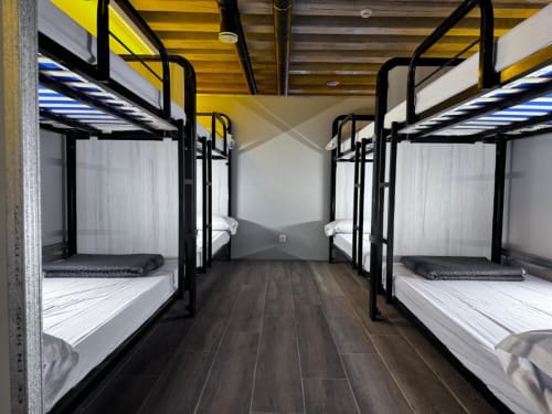 bunk beds in mixed dormitory at Albergue Santiago de Caminha hostel in Caminha, Portugal -Room in a mixed dormitory with air conditioning and Shared bathroom with shower. Tiled floor. Max occupancy: 1 person. Caminho Português da Costa - Camino de Santiago. Coastal way Senda Litoral