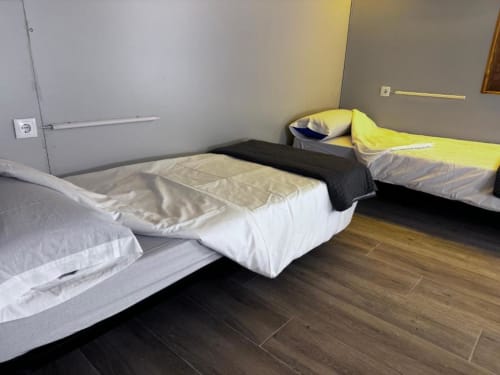 Beds in mixed dormitory at Albergue Santiago de Caminha hostel in Caminha, Portugal -Room in a mixed dormitory with air conditioning and Shared bathroom with shower. Tiled floor. Max occupancy: 1 person. Caminho Português da Costa - Camino de Santiago. Coastal way Senda Litoral