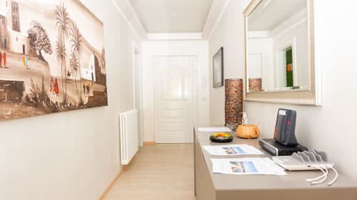 Modern hallway in Versilia Panoramic Luxury apartment, Como Italy, with console table, mirror, and contemporary decor