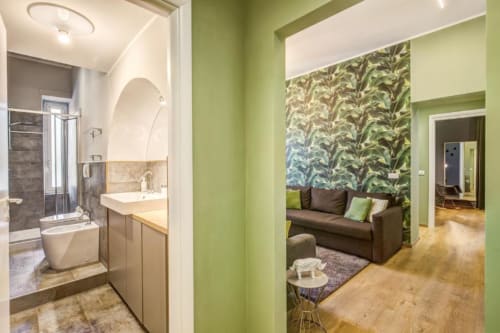 Bright green apartment hallway with modern bathroom and living room seating in Rome's Cinque Terre Stylish apartment