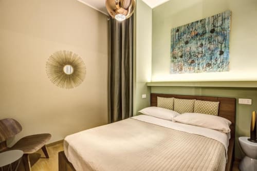 Modern bedroom in Cinque Terre Stylish apartment, Roma with queen bed, green accent wall, and contemporary décor