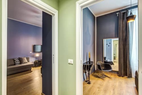 Hallway in Cinque Terre Stylish apartment in Rome showing living room with sofa and bedroom with mirror