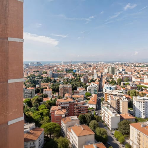 Panoramic city view of Livorno showing red-roofed buildings and urban landscape from Roby's Panoramic House apartment