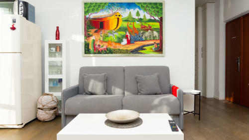 Gray sofa with colorful artwork above in modern Versilia apartment with ocean and mountain views