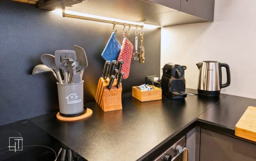 Modern kitchen counter at Hometoday Padova apartment with utensils, coffee maker, kettle, and organized cooking tools under