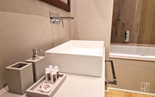 Modern white bathroom at Hometoday Padova apartment with soaking tub, rainfall shower, and luxury toiletries