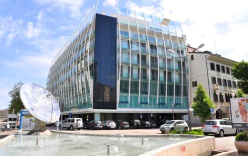 Modern Hometoday hotel building in Padova with glass façade, outdoor plaza, and city views