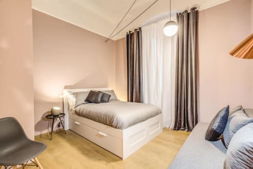 Modern bedroom at Cinque Terre New Liberty apartment in Roma with white bed, wooden floor, and contemporary furnishings