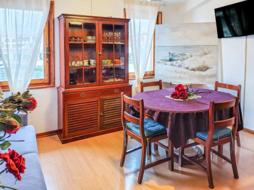 Elegant dining area in Dolce Sardinia apartment at Vesta Home Rent, Padova, with wooden furniture and sea view