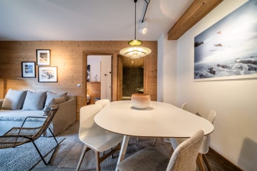 Le Tetralyre apartment at Le Chalet Mont-Blanc with dining table, sofa, and mountain views in Les Houches