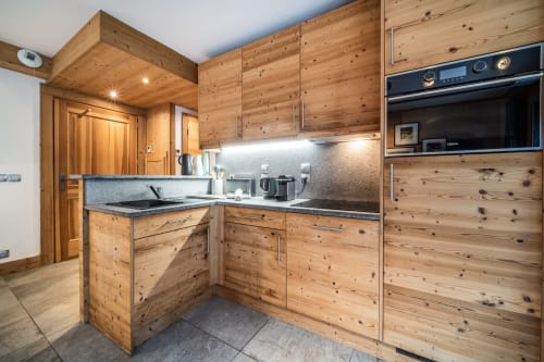 Modern wooden kitchen in Le Tetralyre apartment at Le Chalet Mont-Blanc, Les Houches