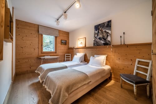 Twin beds in wooden alpine bedroom at Le Chalet Mont-Blanc, Les Houches
