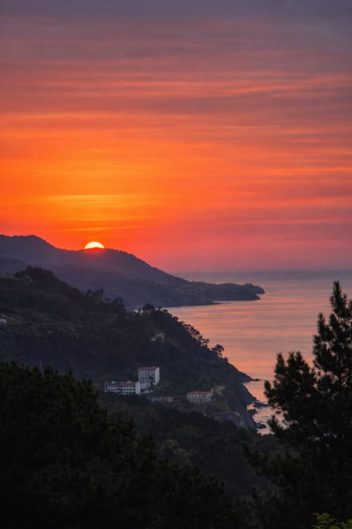 Vista del atardecer sobre la costa vasca cerca de Mutriku con hotel ubicado en la ladera con vistas a la bahía