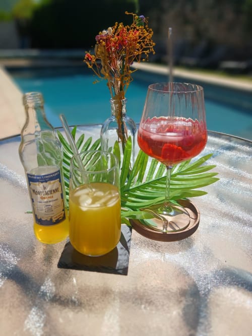 Poolside drinks at Clos De La Gourmanderie, Saint-Lothain: lemonade, red wine, and dried flowers by the pool.