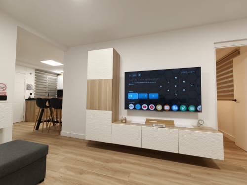 Moderna sala de estar en Bahia Mar Canarias con Smart TV, muebles de madera blanca y piso de madera natural en Vista Pacifica