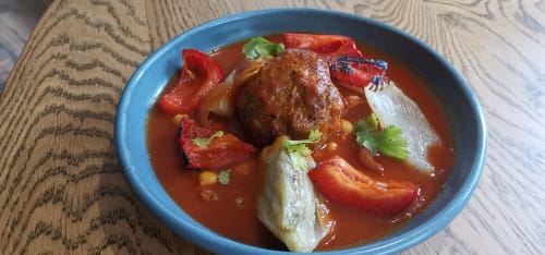 Beef stew with red peppers and cilantro garnish served at Auberge du Pont de l'Alp, Le Monêtier-les-Bains