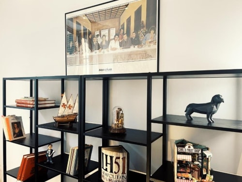 LH51 Rooms display with decorative shelving, model ship, figurines, books, and framed artwork in Italian boutique hotel